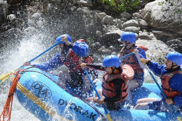 a group of people riding skis on a raft